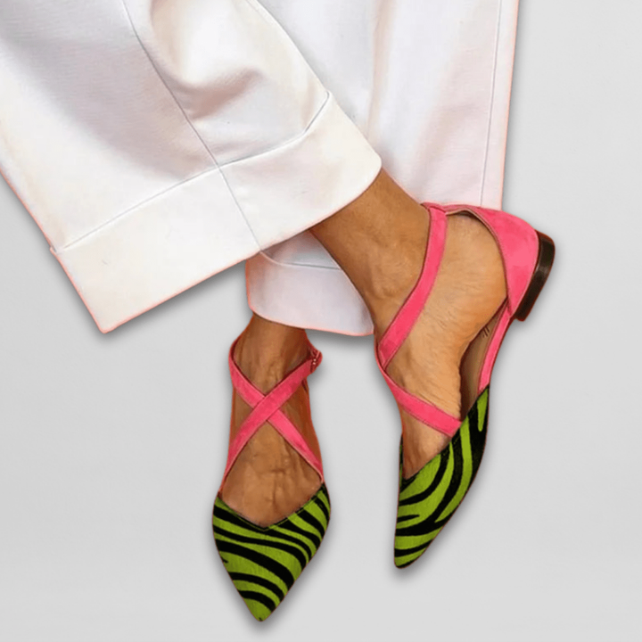 Zebra-print pointed flats featuring green striped toe and pink suede ankle straps