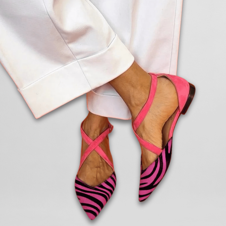 Pink suede crisscross flats with vibrant pink zebra-print pointed toe design