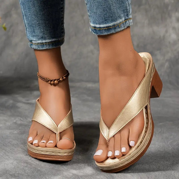 Metallic gold thong sandals with chunky block heel and platform sole