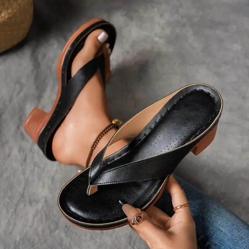 Black leather thong sandal with contrast stitching and stacked wooden heel