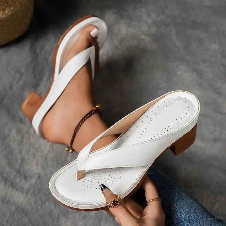 White crisscross strap sandal displaying platform sole and heel height