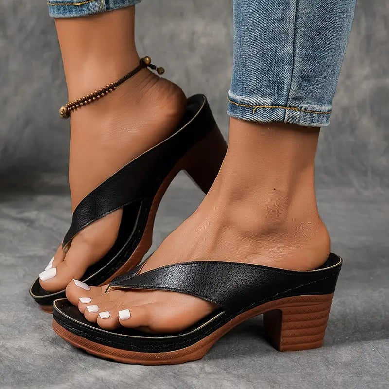 Black crisscross thong sandals with wedge platform and stacked heel