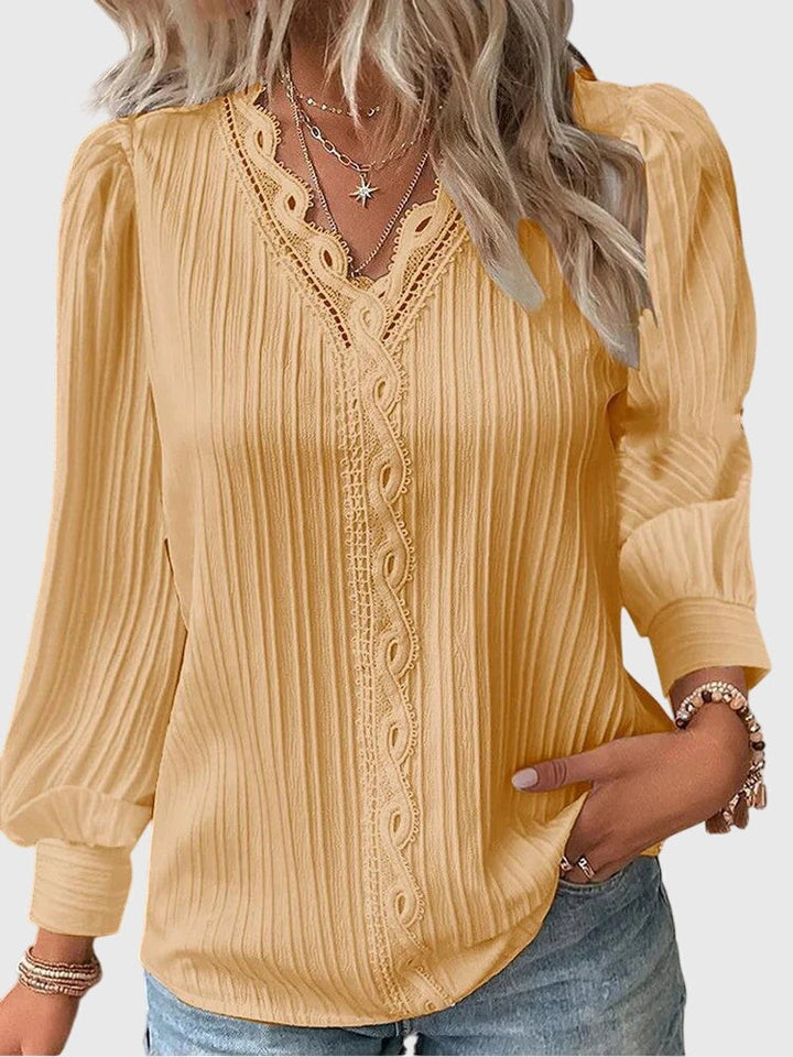 mustard yellow pleated blouse with lace-trim V-neck and puff sleeves