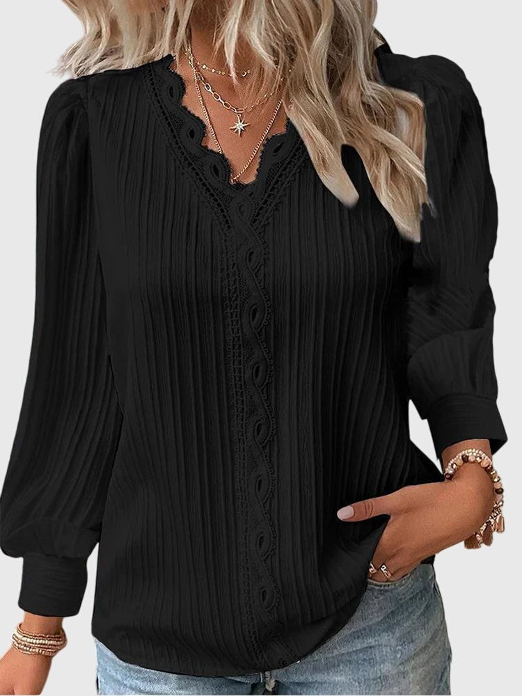 black pleated V-neck blouse with scalloped lace trim and puff sleeves
