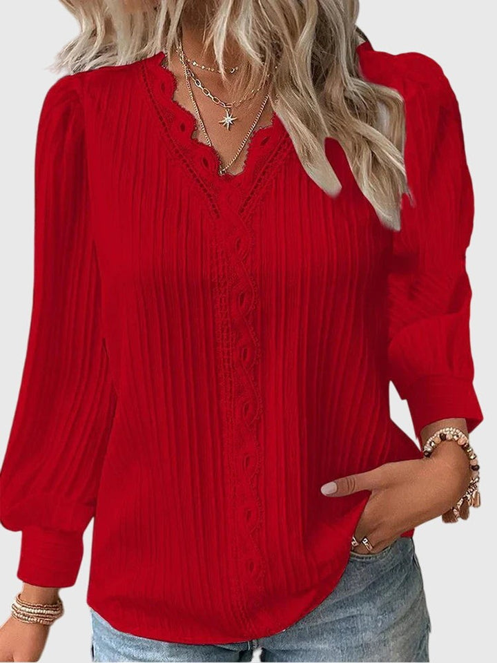 red pleated V-neck blouse with scalloped lace trim and puff sleeves