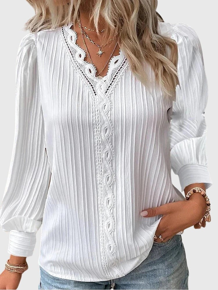 white pleated blouse with crochet lace V-neckline and long puff sleeves
