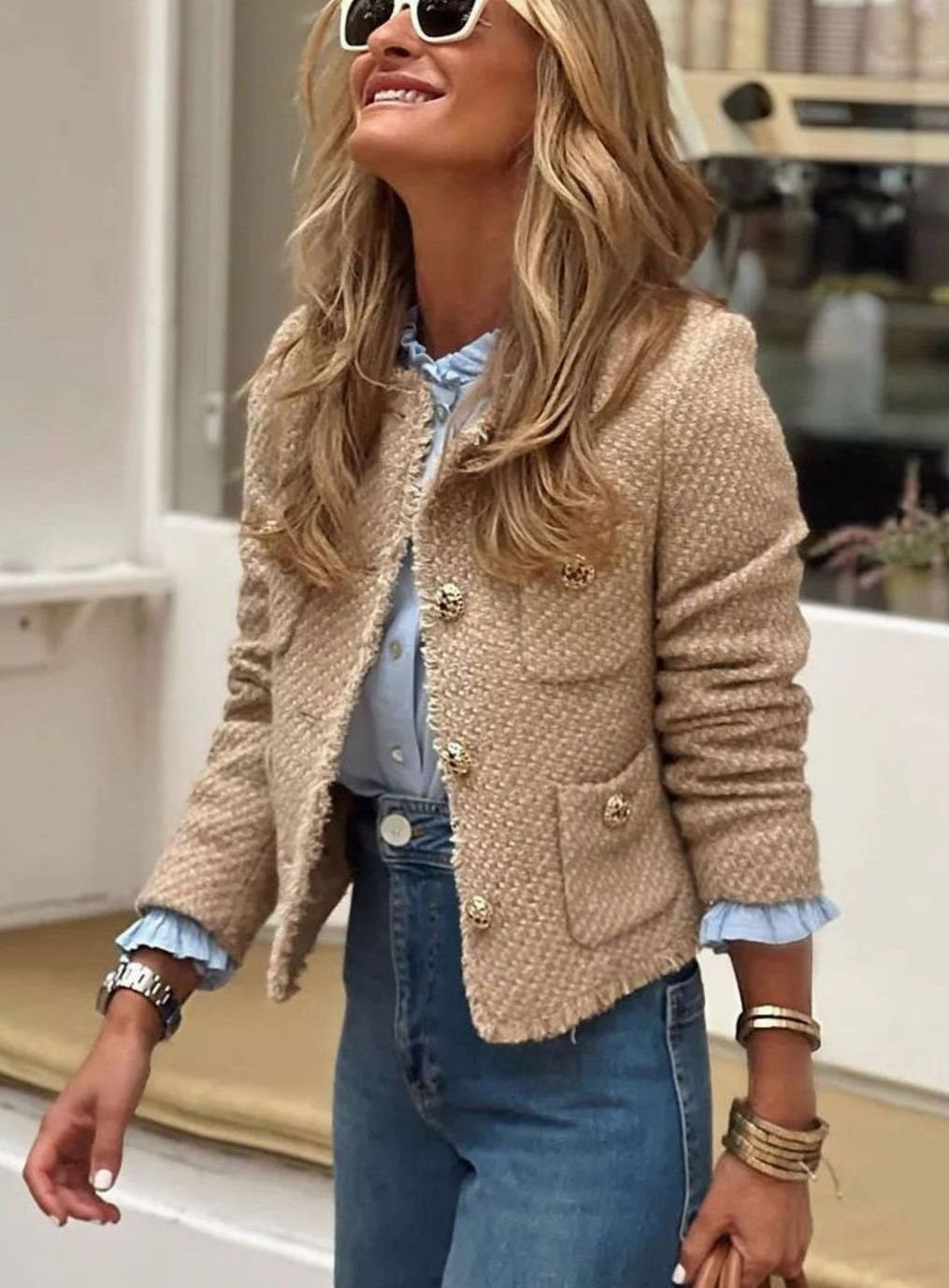 Beige tweed cropped blazer with frayed trim and gold buttons, worn over denim