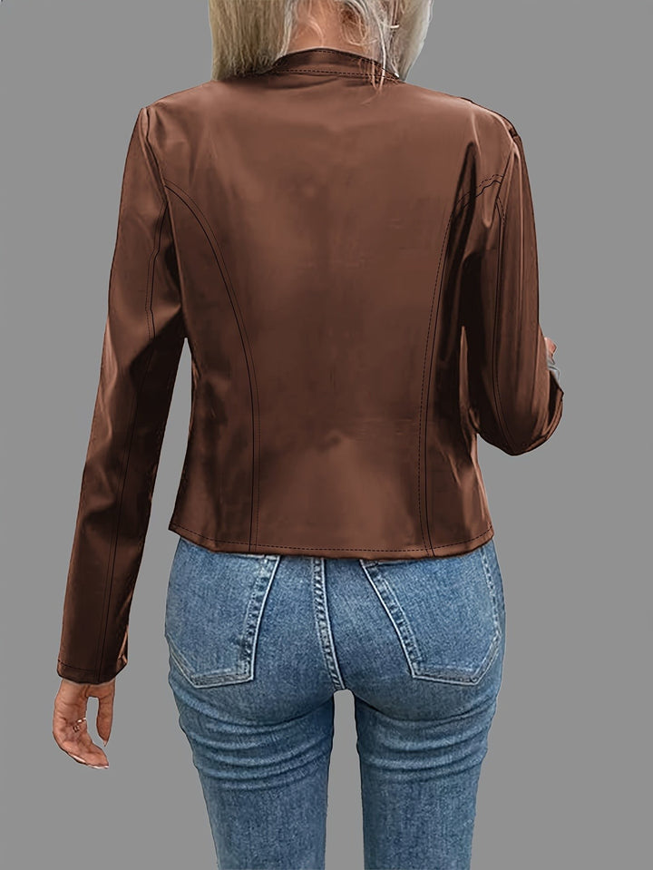 Back view of cropped brown faux leather jacket paired with denim jeans