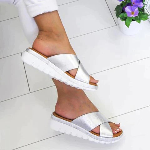 silver criss-cross strap slide sandals with white platform wedge sole