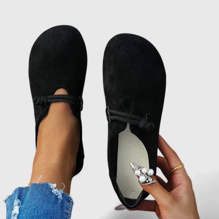Black suede orthopedic loafers featuring braided rope mary jane strap