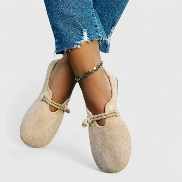Beige suede mary jane flats worn with cropped raw-hem jeans