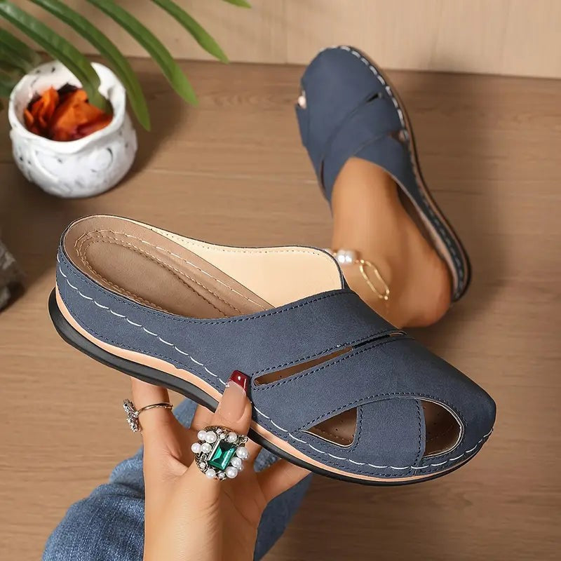 Navy blue wedge sandals featuring cutout straps and topstitched trim