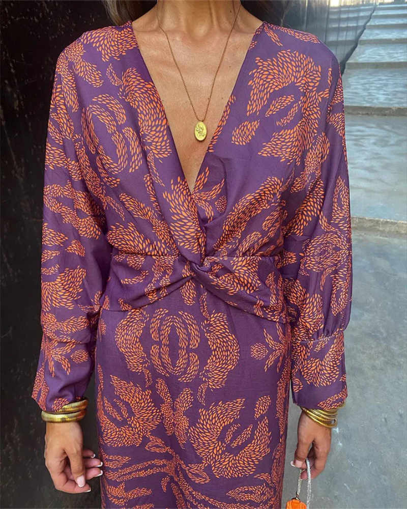 Purple and orange paisley maxi dress close-up showing twist waist design
