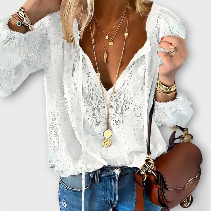 White lace V-neck blouse with long sleeves and tie-front detail