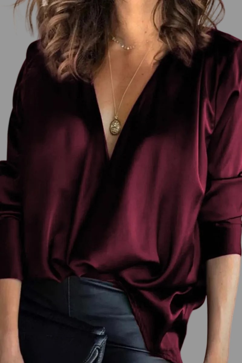 Burgundy satin blouse featuring deep V-neck and draped wrap front