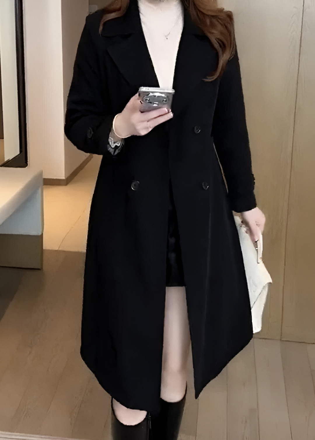 Black double-breasted trench coat with notched lapel and long sleeves