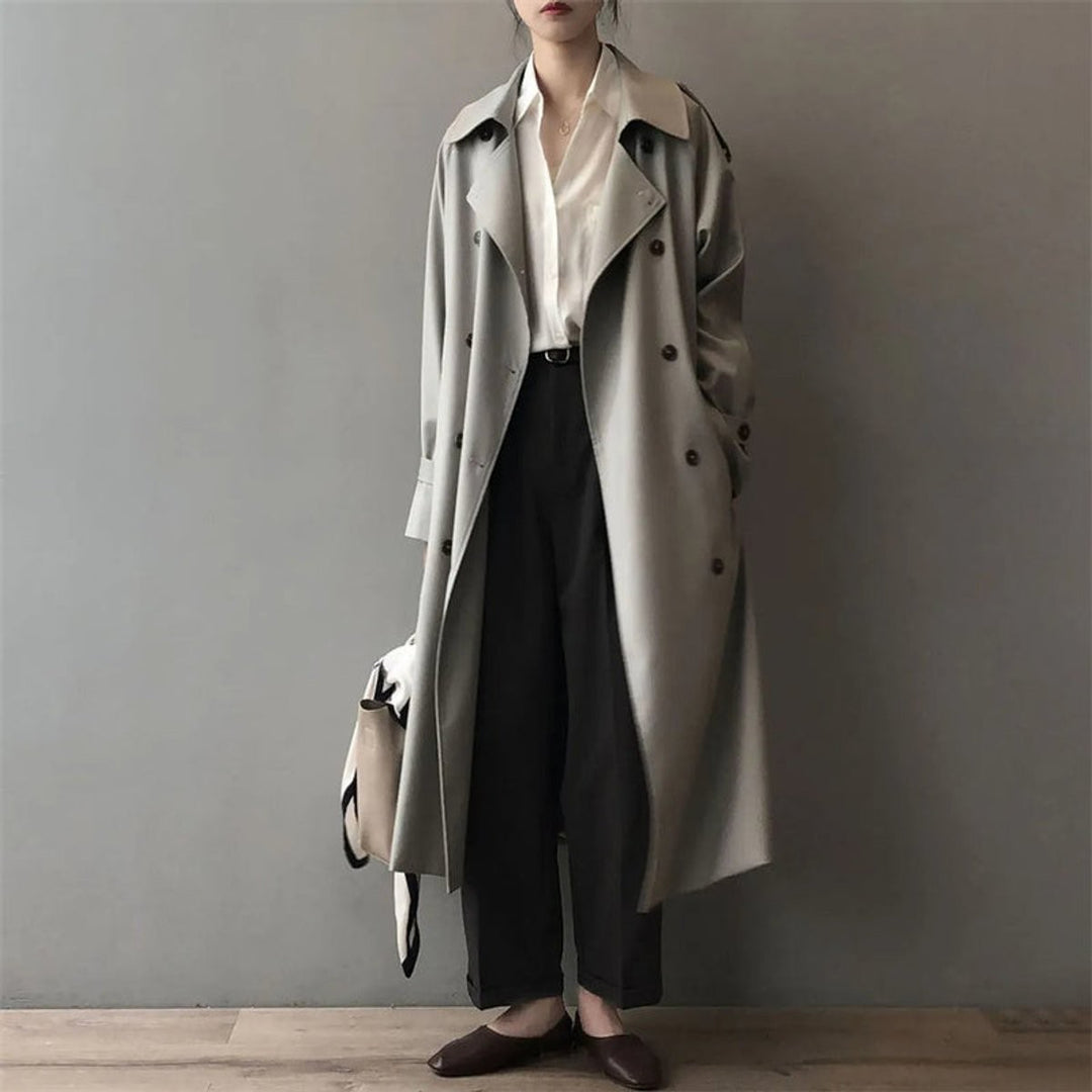 Oversized grey trench coat with contrast collar and wide lapels, worn open