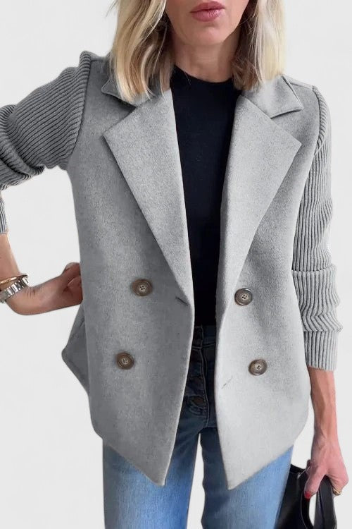 Grey double-breasted blazer paired with ribbed knit contrast sleeves