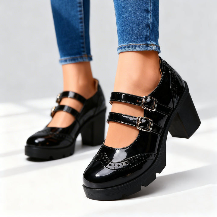 Black patent leather Mary Jane pumps with brogue detailing and block heel