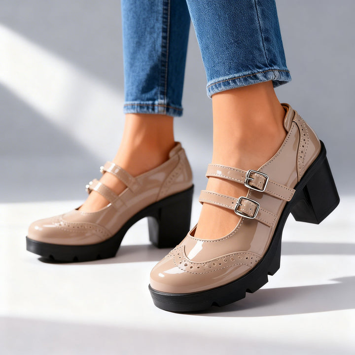 Taupe patent Mary Jane platform heels with silver buckle straps, studio shot