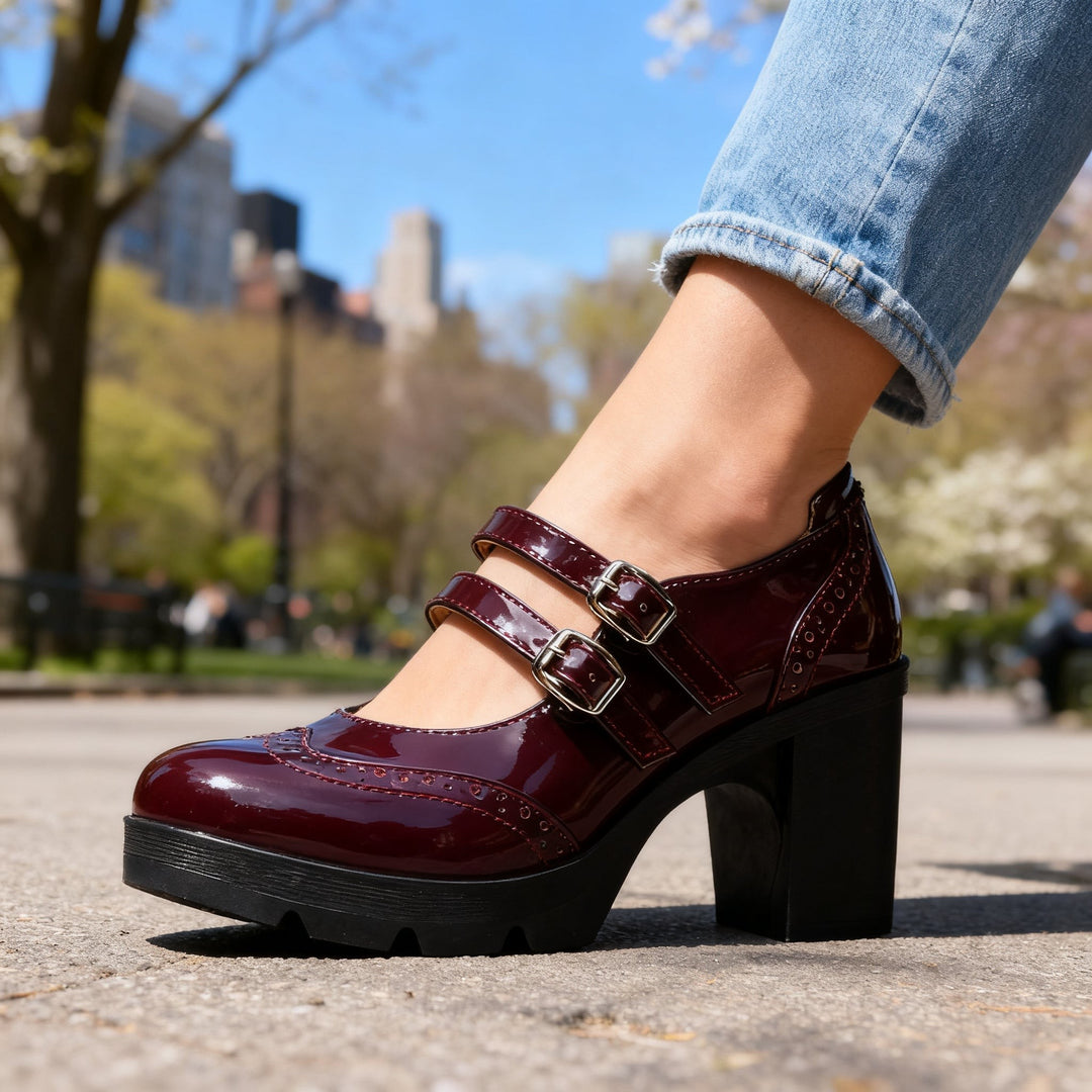 Burgundy patent Mary Jane heel close-up highlighting brogue stitching and buckles