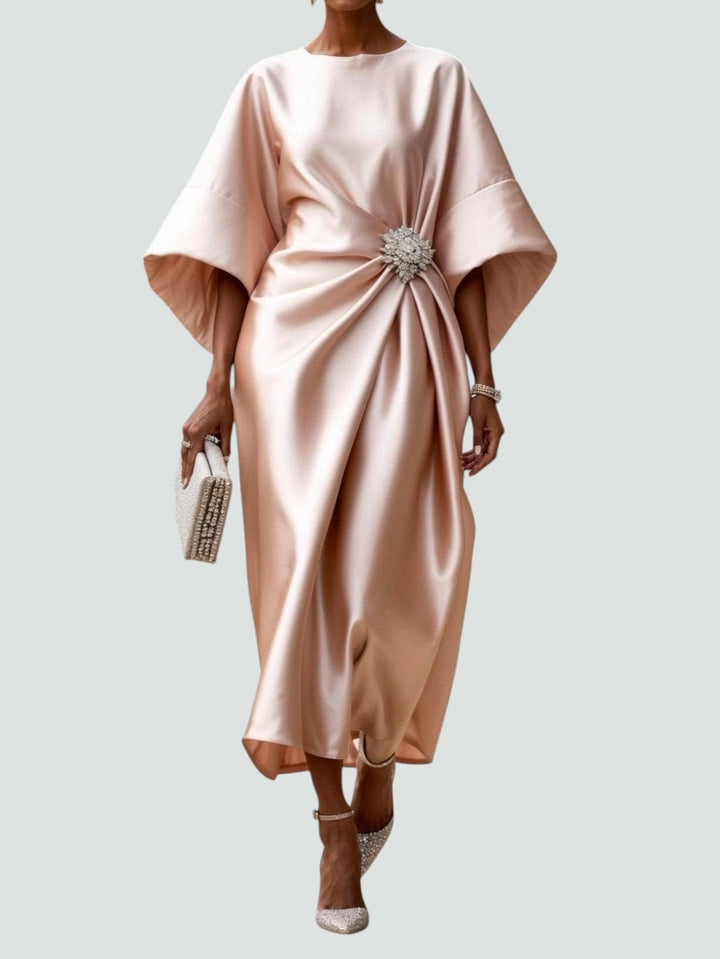 Blush pink satin midi dress with draped bodice and rhinestone brooch