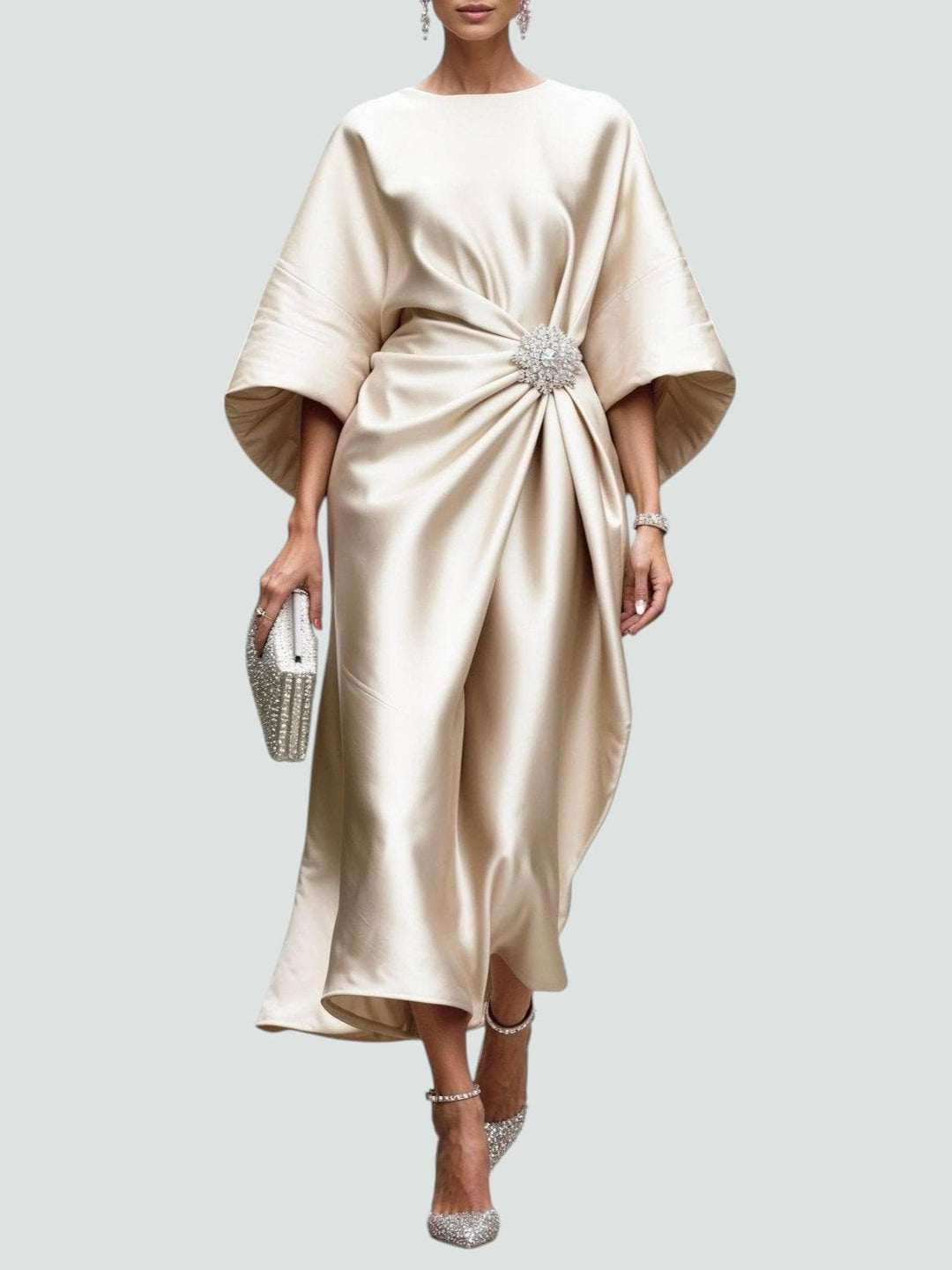 Champagne satin kaftan dress with gathered waist and crystal brooch accent