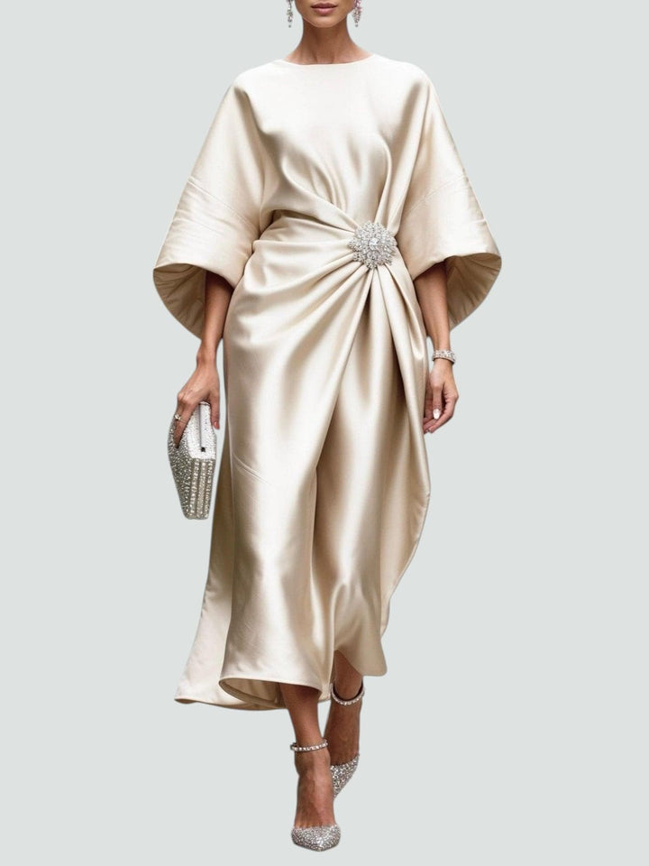 Champagne satin kaftan dress with gathered waist and crystal brooch accent