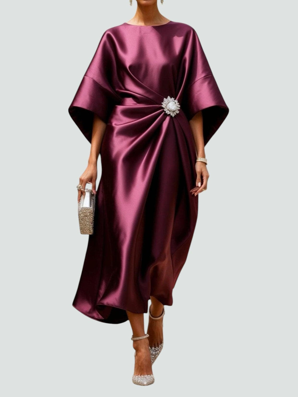 Burgundy satin kaftan dress featuring ruched waist and jeweled brooch accent