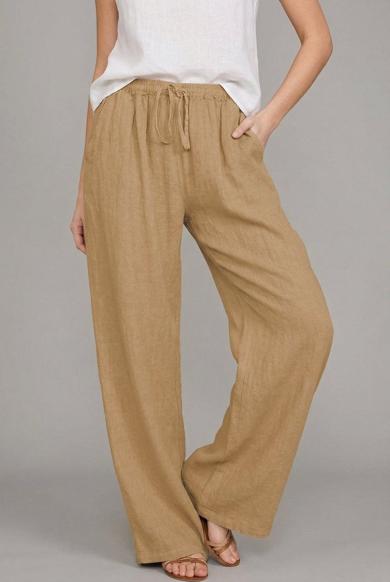 Front view of tan linen drawstring pants featuring relaxed wide leg silhouette