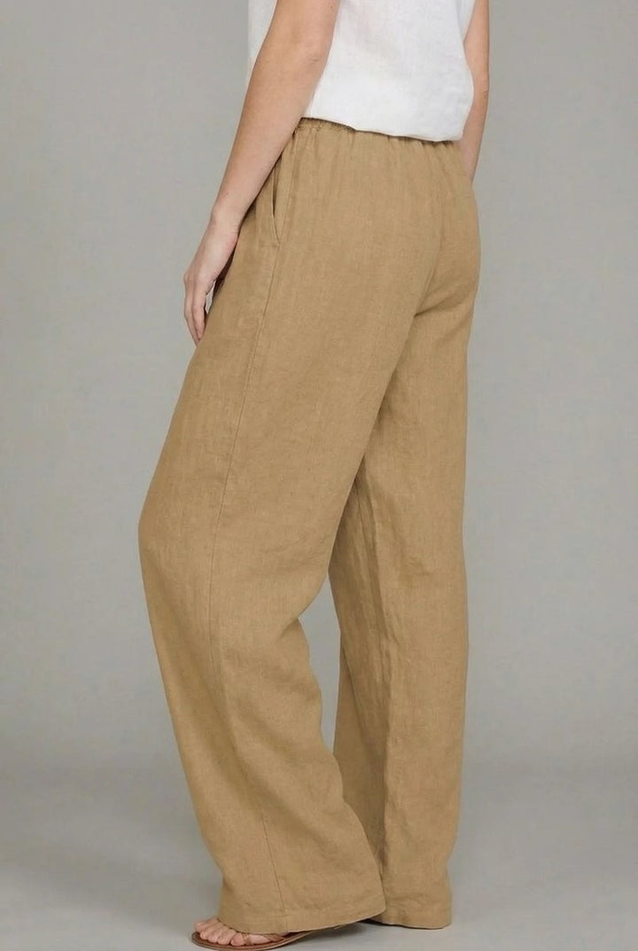 Back view of tan linen relaxed pants showing elastic drawstring waistband detail
