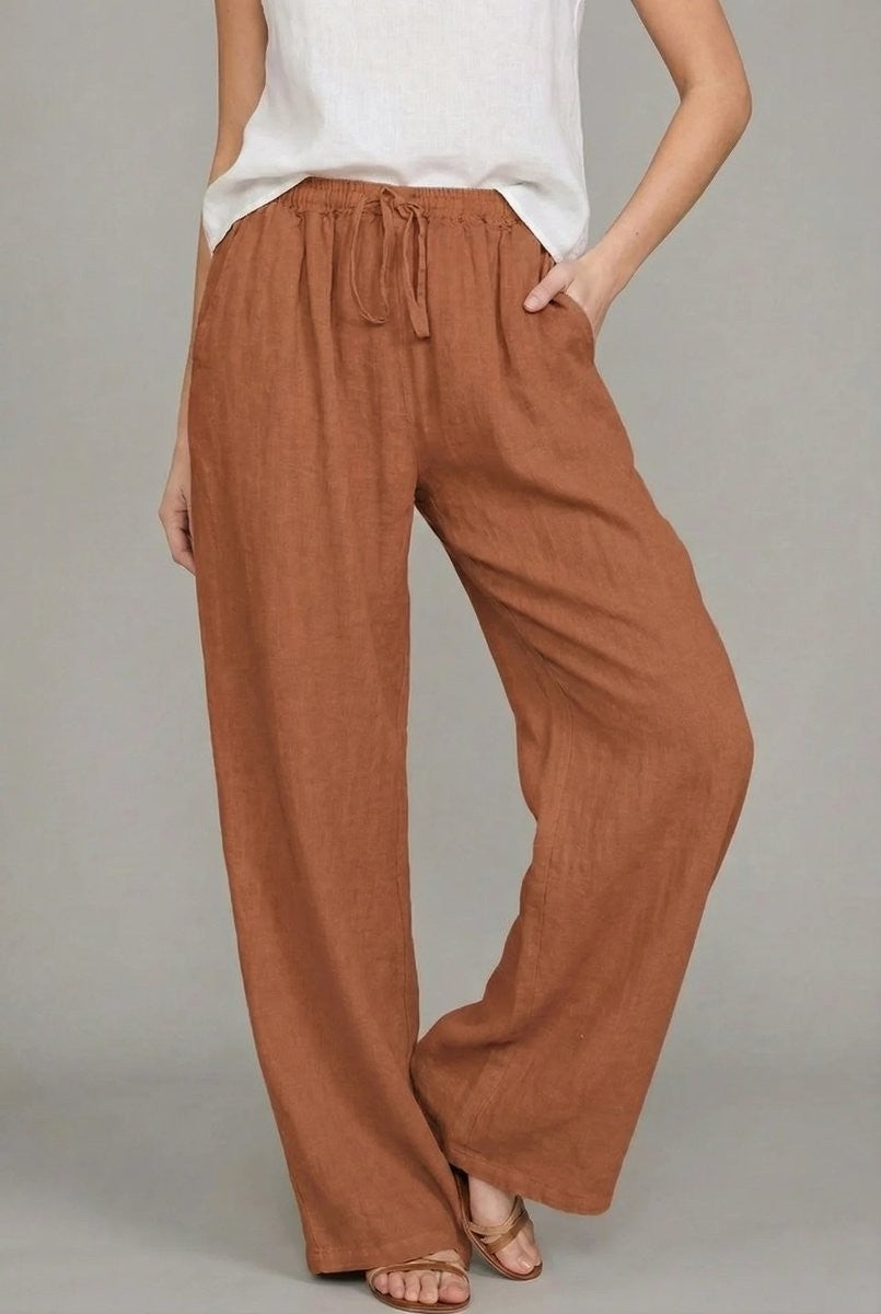 Rust brown linen relaxed pants featuring wide leg cut and tie waist
