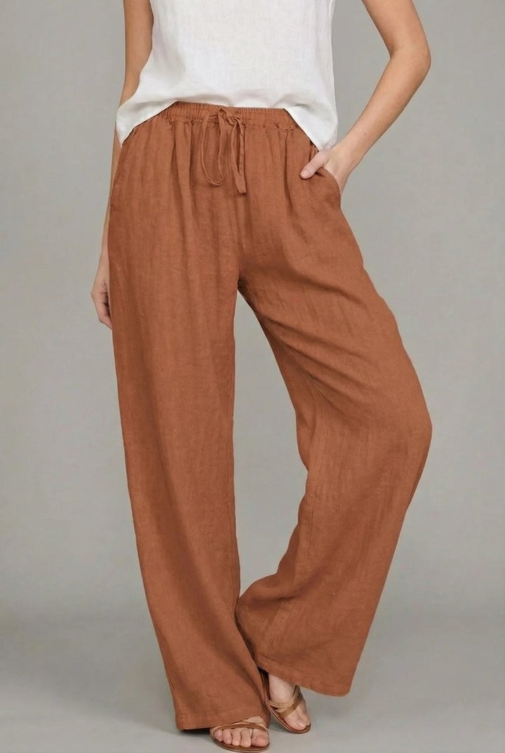 Rust brown linen relaxed pants featuring wide leg cut and tie waist