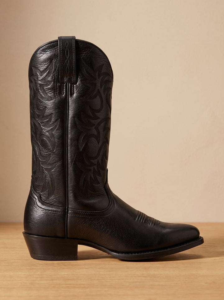 Side profile of black leather cowboy boot showing pull tab and stitched detailing
