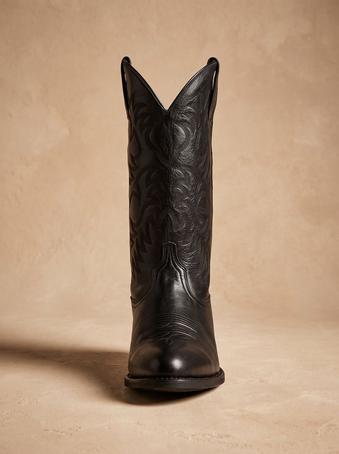Front view of black leather cowboy boot highlighting V-shaped shaft and embroidery