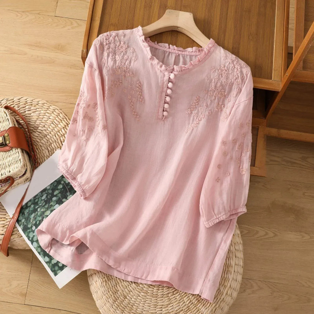 pink floral embroidered blouse with ruffled V-neck and button placket