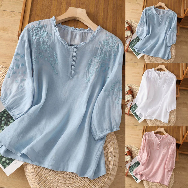 floral button-front blouse shown in blue, white, and pink color options