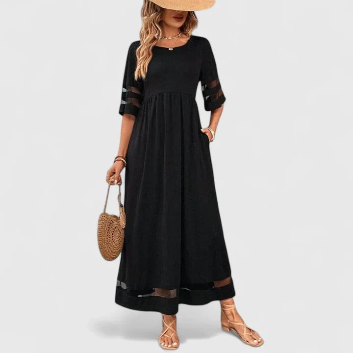 Black maxi dress featuring sheer mesh sleeve and hem stripes