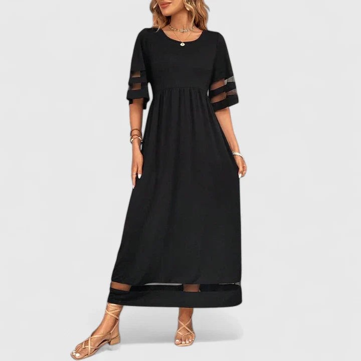 Black A-line maxi dress showing sheer mesh trim detail