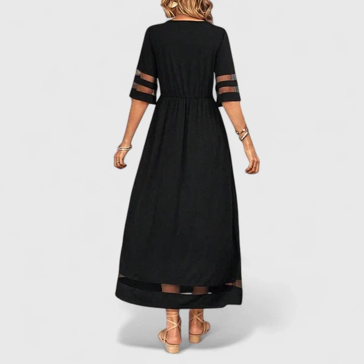 Back view of black maxi dress with mesh sleeve accents