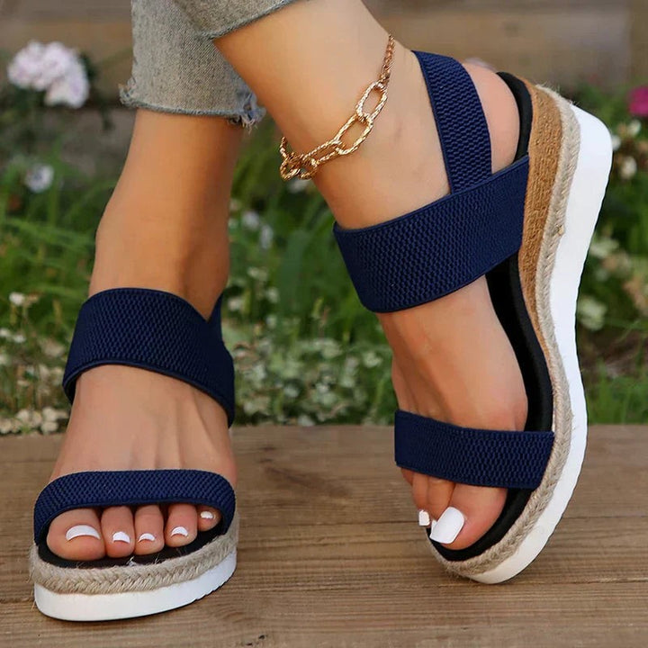 Navy blue wedge sandal with crisscross straps and jute trim