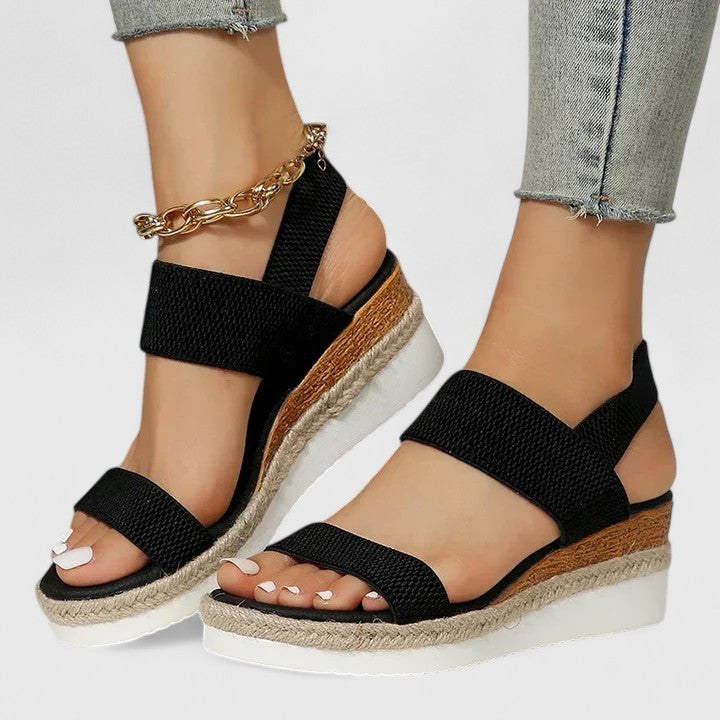 black espadrille wedge sandal with elastic straps and gold anklet