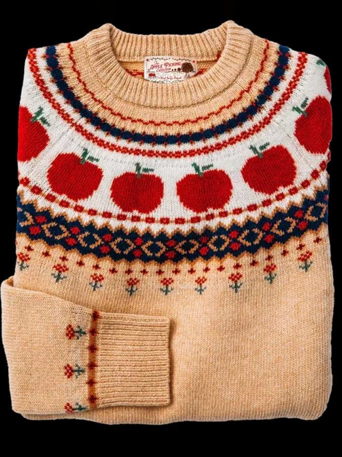 Tan Fair Isle sweater with knit apple pattern around round neckline