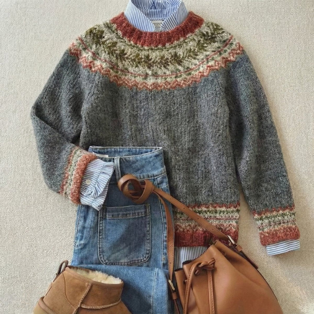 Gray Nordic knit sweater with rust and olive patterned trim, layered over denim