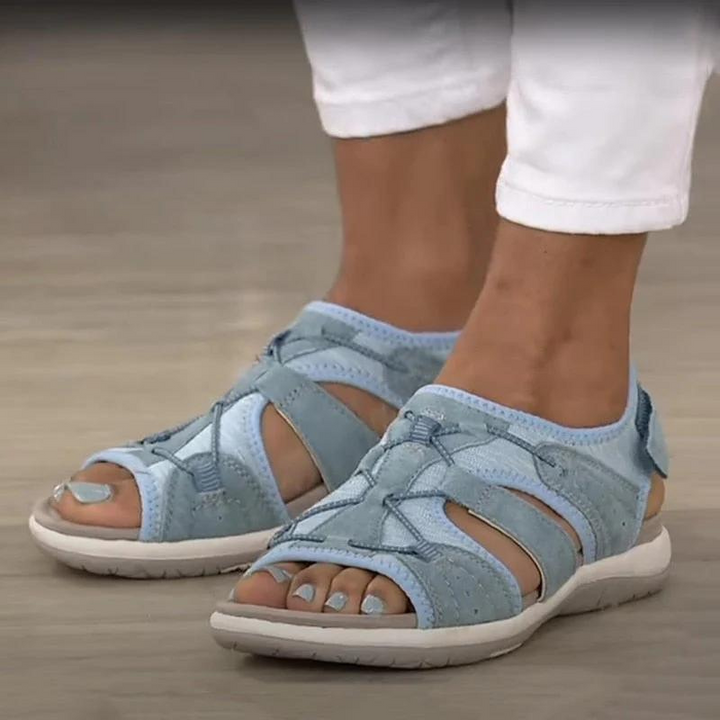 Light blue suede fisherman sandals with crisscross lace detail on feet