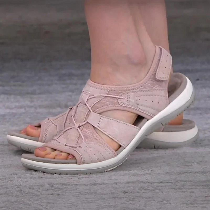 Dusty pink orthopedic sandals featuring crisscross straps and cushioned sole