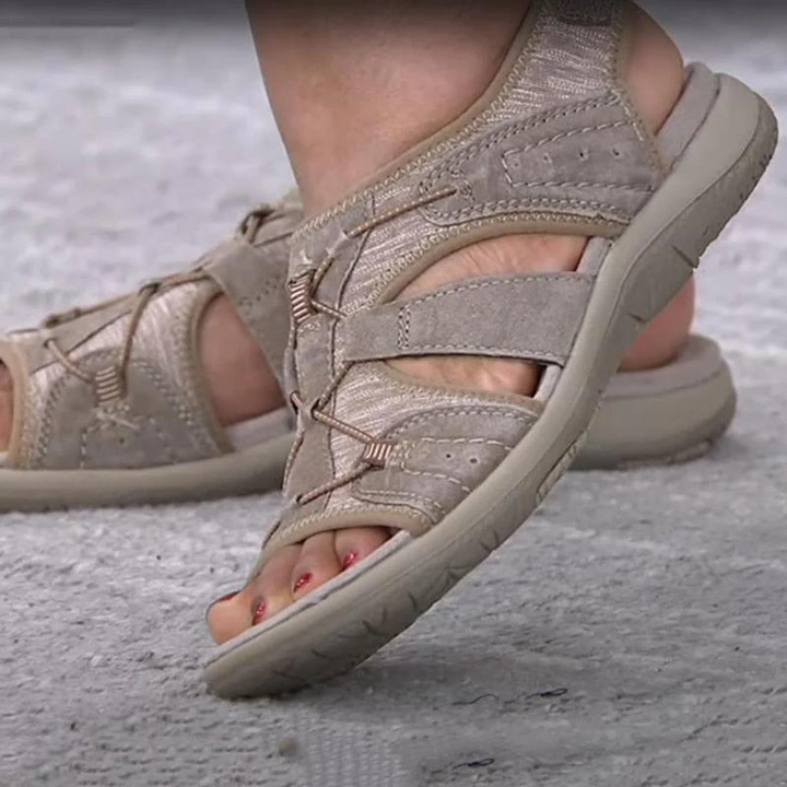 Beige suede sandals with crisscross lacing and thick comfort outsole