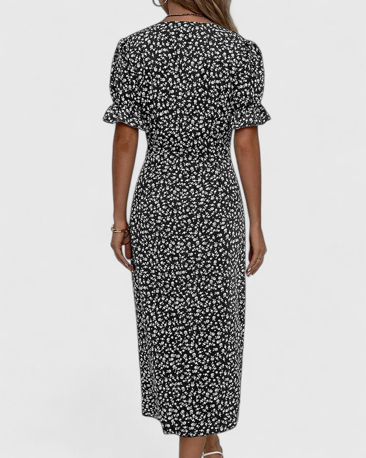 Back view of black floral midi dress with puff sleeve design