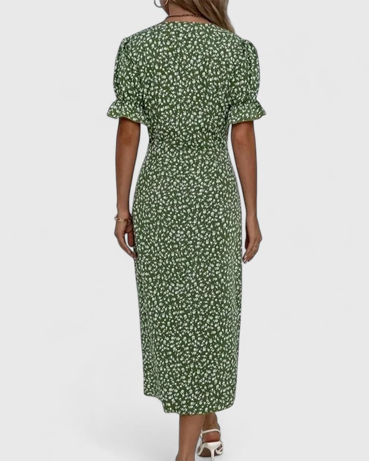 Back view of green floral midi dress showing puff sleeves and fit