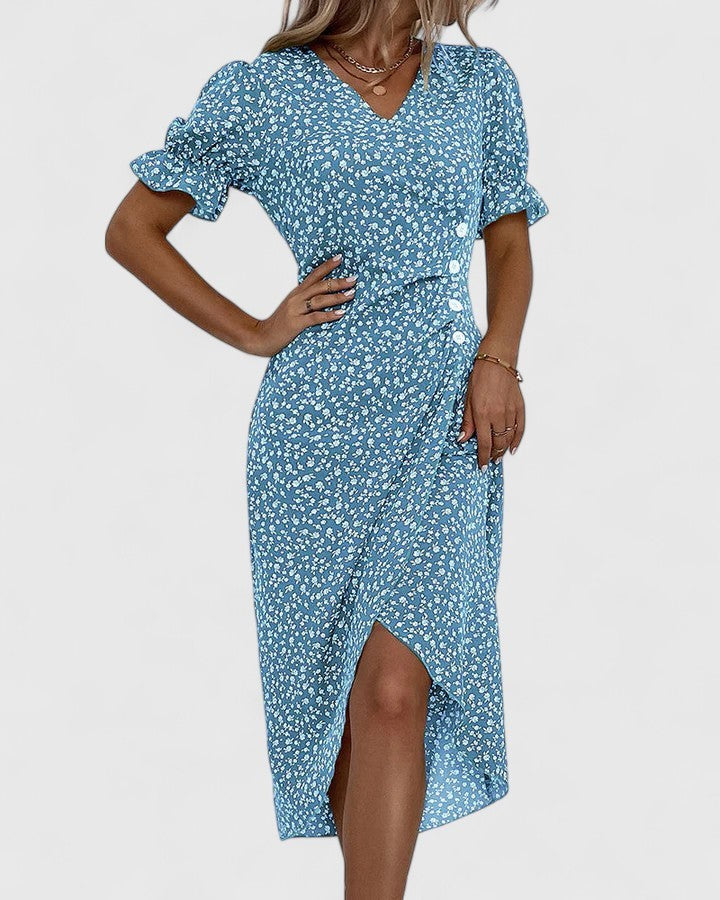 Side view of blue floral midi dress with button placket and slit